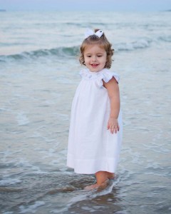 Connie's granddaughter Maddie modeling her sea shell dress by Petit Bebe.